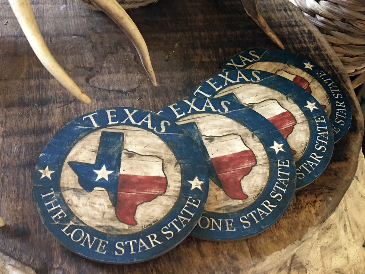 Texas State with blue border Coasters on natural hardwood